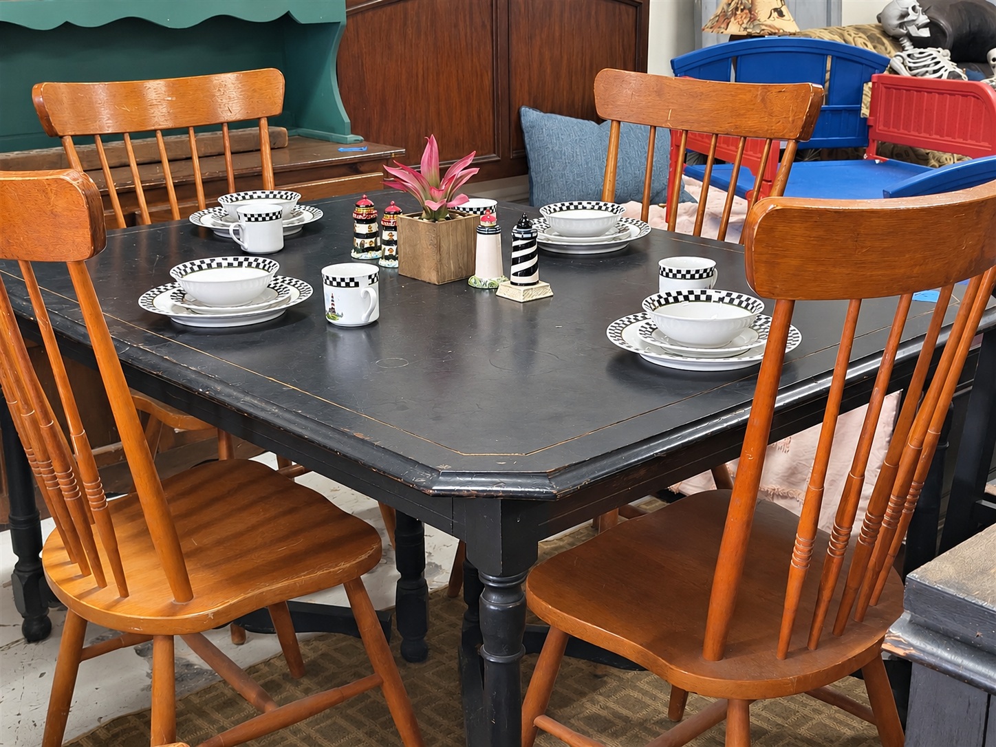 Dining table and wooden chairs photographed inside the shop